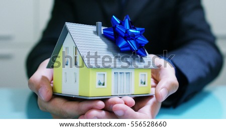 insurance of fire and theft .the hands of an insurer or real estate agent showing a house with floor plan and documents with ensured house keys.concept of home protection, family, insurance.rent house