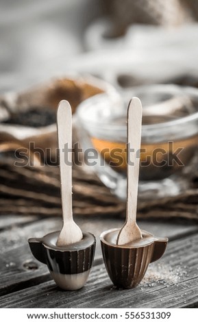 Tea and candy cane on wooden background