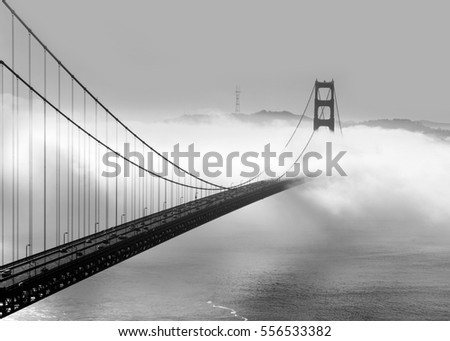 Panoramic view of the western span of the Golden Gate Bridge on a foggy winter morning viewed from Battery Spencer, a Fort Baker site - black and white rendering.

 Royalty-Free Stock Photo #556533382