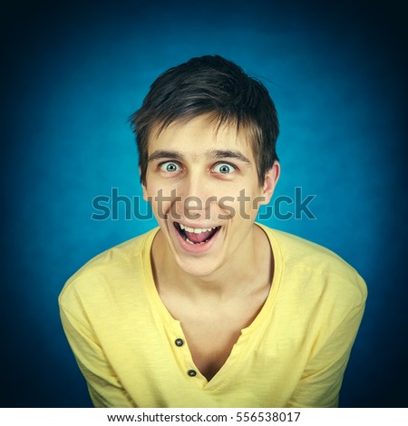 Toned Photo of Cheerful Young Man on the Dark Background closeup