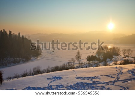 Fantastic evening landscape in a colorful sunlight. Dramatic wintry scene. 