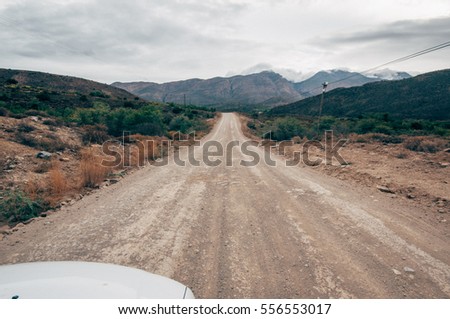 Dusty road leading to unknown destination, travel and concept photos. Scene photographed in the little karoo region,South Africa