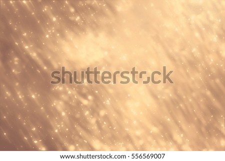 Golden abstract sparkles or glitter lights. Festive gold background.defocused circles bokeh or particles. Valentines day template