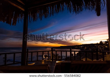 Sunset at the resort, beach umbrellas and sunbeds.