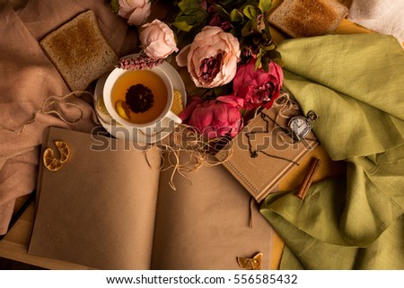 Craft paper note with cup of tea, flowers, peonies, old vintage clock. Retro background. Modern toning. Copyspace for text, picture and design