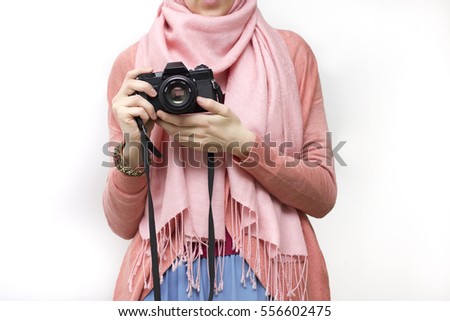 Muslim woman taking a photography with a vintage slr camera, no face