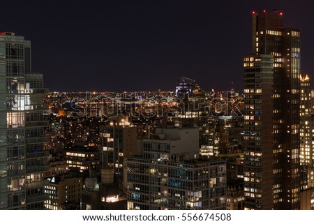 New York City skyline at nighttime with bright lights from the buildings