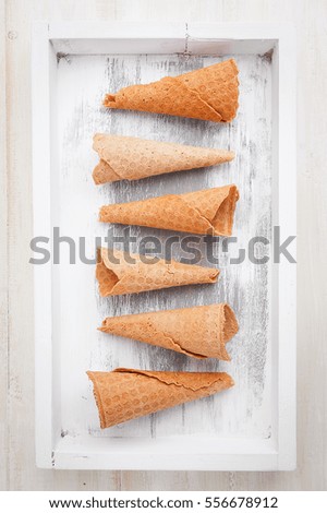 a glass of ice-cream on a wooden background