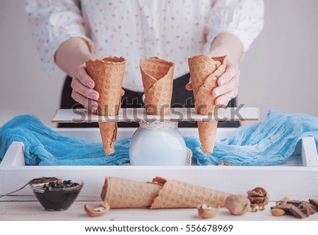 a tray of ice cream, jam and cups of powder on a wooden background