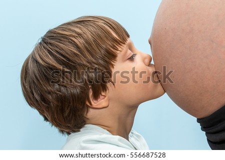 Girl kissing pregnant mom
