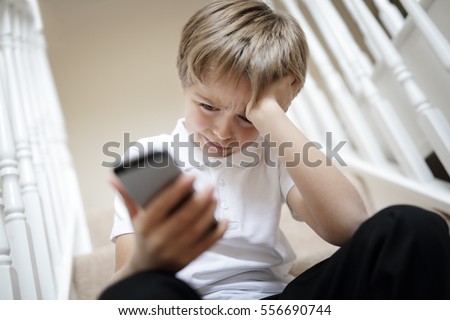 Cyber bullying by mobile cell phone text message Royalty-Free Stock Photo #556690744