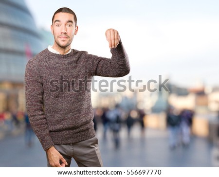 Happy young man doing a gesture of show