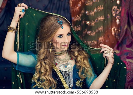 ?lose-up portraits of cute girl wrapped in green sari with teak over her head