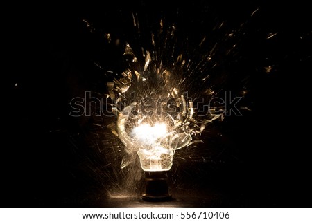 Explosion of light bulb Royalty-Free Stock Photo #556710406