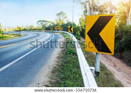 Curve warning sign on the road 