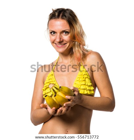 Beautiful blonde woman in bikini holding bananas