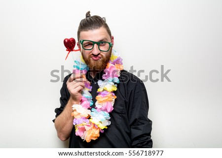 lonely hipster beard guy in photo booth with floral props separated on white background