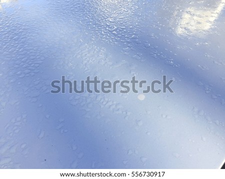 Blurred drops of rain on copyspace surface background, closeup picture