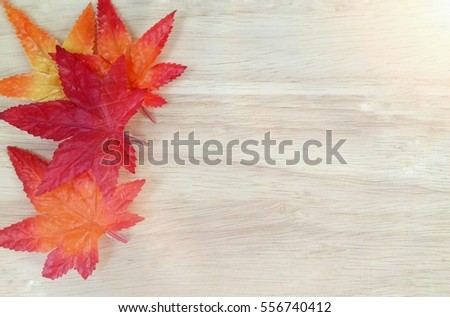 autumn maple leaves on wooden background with Flares. free space for text 