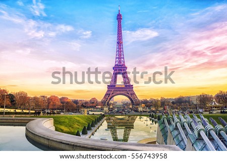 Eiffel Tower at sunset in Paris, France. Romantic travel background. Royalty-Free Stock Photo #556743958