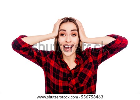 Portrait of happy shocked brunette touching her head
