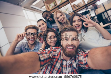 Selfie of young smiling teenagers having fun together Royalty-Free Stock Photo #556760875