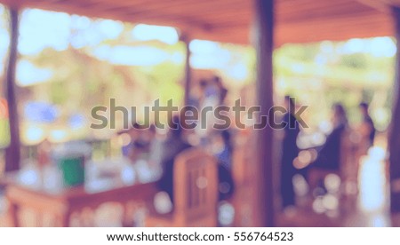 image of blur restaurant or coffee shop on day time with bokeh for background usage . (vintage tone)