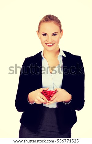 Young happy business woman holding red wallet