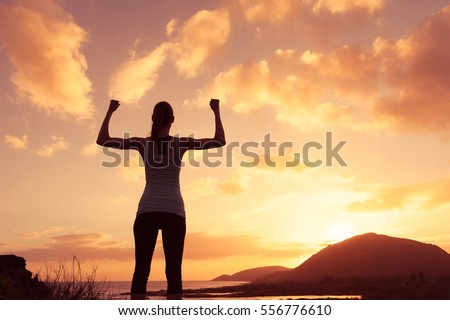 Strong and confident woman flexing her muscle.  Royalty-Free Stock Photo #556776610