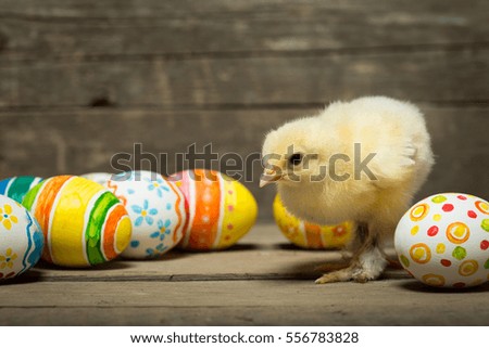 Easter eggs and chicken on wooden boards