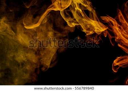 Abstract smoke. Personal vaporizers fragrant steam. The concept of alternative non-nicotine smoking. Yellow smoke on a black background. E-cigarette. Evaporator. Taking Close-up. Vaping.