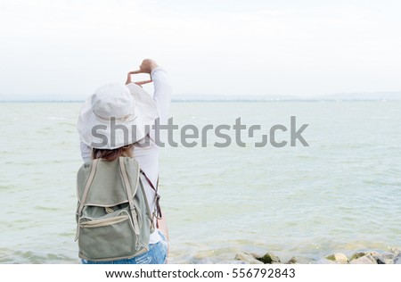 Hipster young woman show finger frame for take picture dam, concept travel