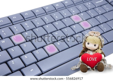 A little cute girl doll holding a big heart with Keyboard, Valentine concept