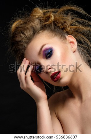 Girl with bright make-up and colourful hairstyle.