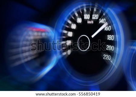 Motion blur of modern car instrument panel dashboard with blue illuminated display, rev up. Royalty-Free Stock Photo #556850419