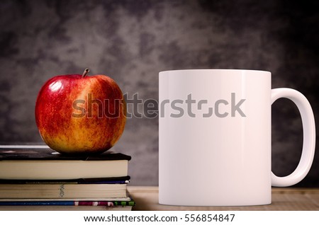 Mockup Styled Stock Product Image, white mug that you can add your custom design/quote to. Mug is next to books with an apple on them.