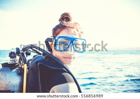 Portrait of a young girl diver on a sunny day. Royalty-Free Stock Photo #556856989