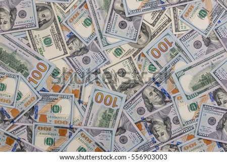 Pile of new and old one hundred dollar bills bills. Royalty-Free Stock Photo #556903003