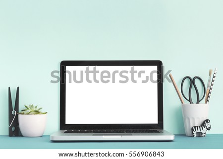 Mock up laptop, notebook on young student desk. Cyan pastel colors. Royalty-Free Stock Photo #556906843