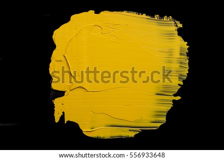 Yellow oil paint on a black background
