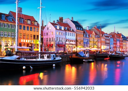 Scenic evening panorama of famous Nyhavn pier architecture in the Old Town of Copenhagen, Denmark Royalty-Free Stock Photo #556942033