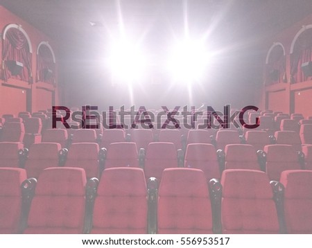RELAXING words with blurred cinema background - movies and entertainment concept