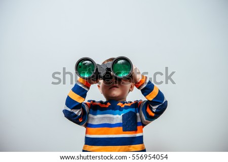 Boy with binoculars. little boy looking through binoculars