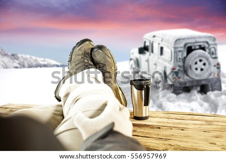 men legs with wooden table and car in snow 