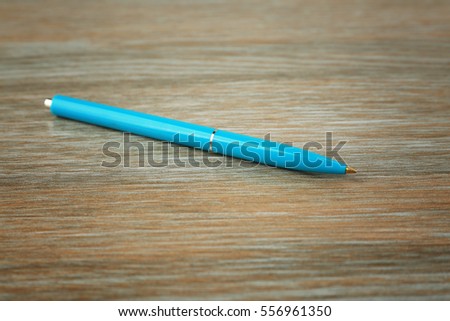 Blank ballpoint pen on wooden background
