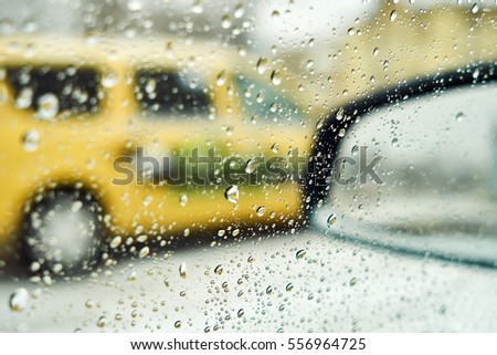 Blurred winter picture. Blurred background city street in winter in the snow from the car window. Taxi waiting passengers. Basic background for design
                               