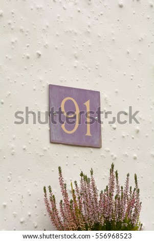 House number 91 sign on wall