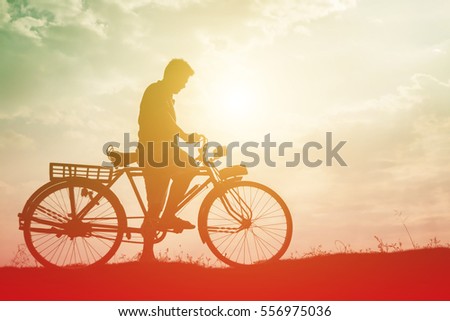 silhouette of bicycle with man