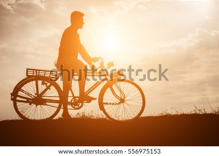 silhouette of bicycle with man