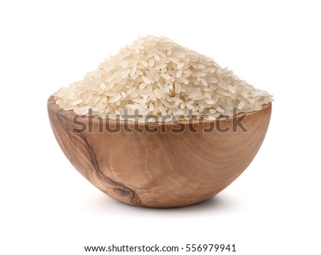  Uncooked dry rice in wooden bowl isolated on white Royalty-Free Stock Photo #556979941